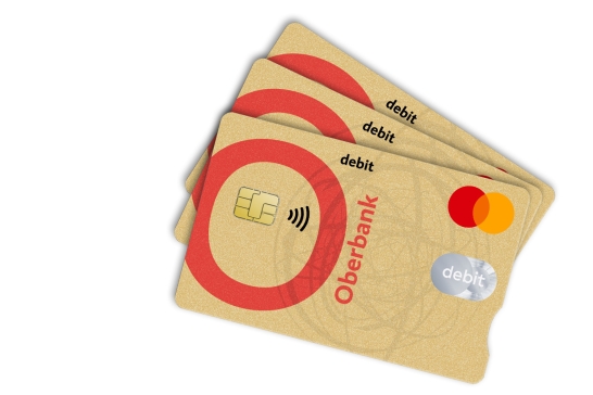 Lächelnde Frau schaut auf ihre Oberbank Debitkarte