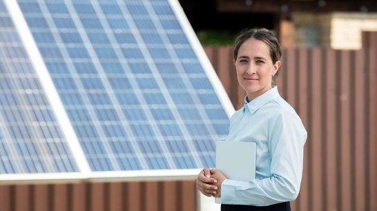 Dame vor Photovoltaik-Anlage
