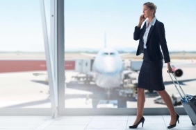 Dame am Flughafen mit Handy in der Hand